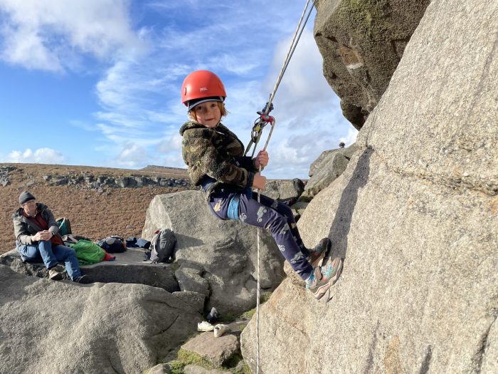 A young climber learning to abseil!