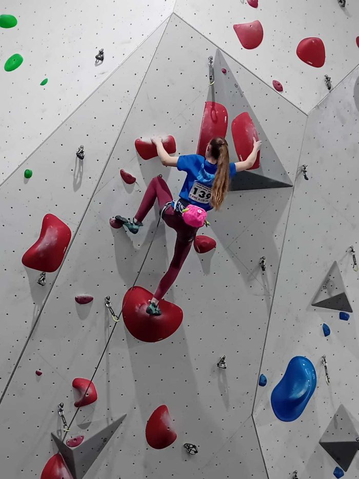 Sienna climbing a difficult lead route at the Youth Climbing Series National Finals at Parthian Southampton.